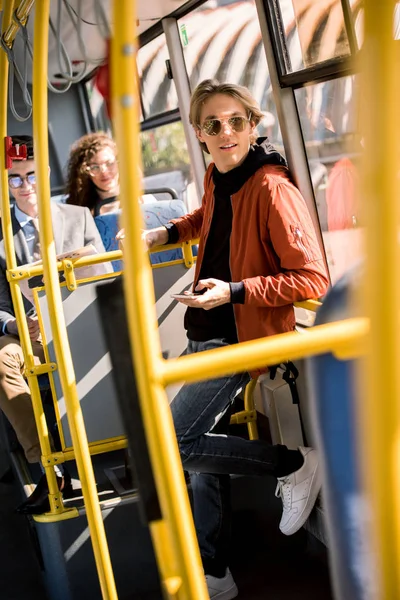 Man using smartphone in bus — Stock Photo