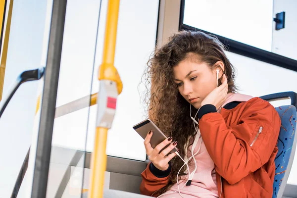 Girl using smartphone in bus — Stock Photo