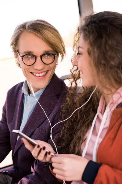 Couple with smartphone in bus — Stock Photo