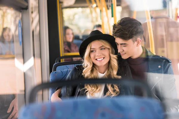 Happy young couple in bus — Stock Photo