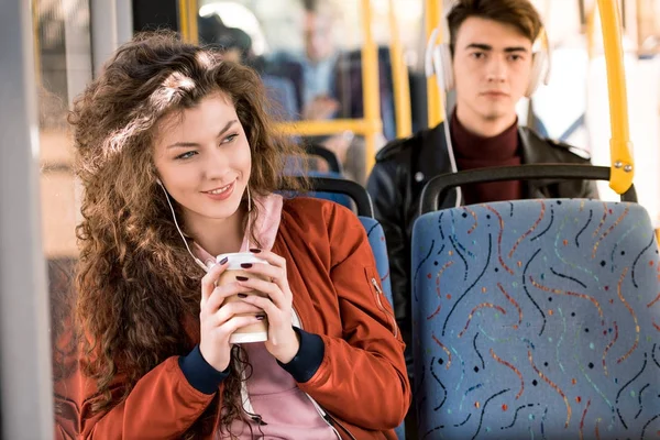 Girl drinking coffee in bus — Stock Photo