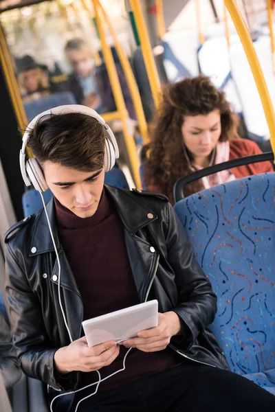 Man in headphones with digital tablet — Stock Photo