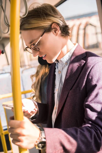 Man using smartphone in bus — Stock Photo