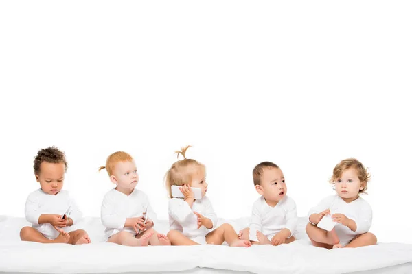 Multicultural toddlers with smartphones — Stock Photo