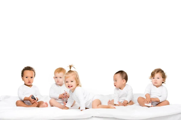 Niños pequeños multiculturales con smartphones - foto de stock
