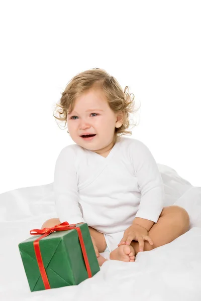 Toddler girl with wrapped present — Stock Photo