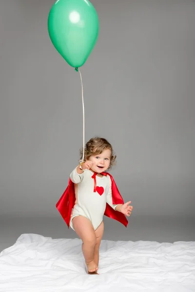 Happy toddler with balloon — Stock Photo