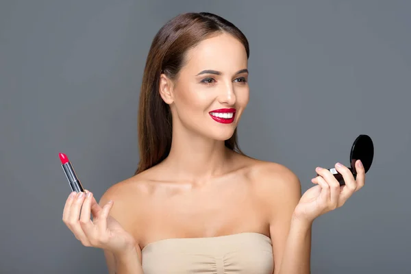 Jovem mulher aplicando maquiagem — Fotografia de Stock