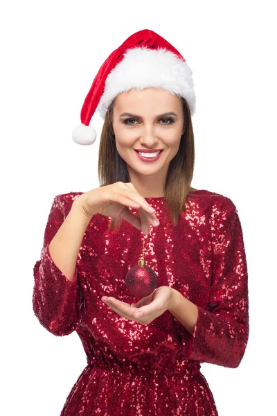 Girl in santa hat holding bauble — Stock Photo