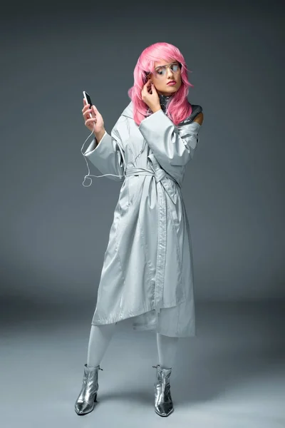Stylish girl with earphones and smartphone — Stock Photo