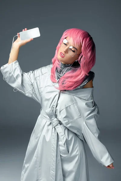 Stylish girl with earphones and smartphone — Stock Photo