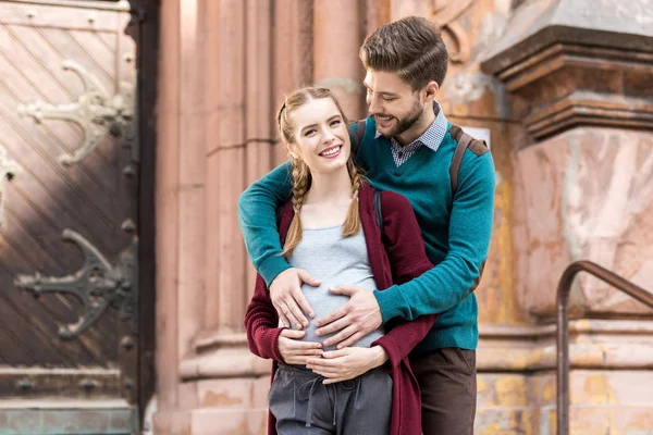 Man touching belly of pregnant wife — Stock Photo