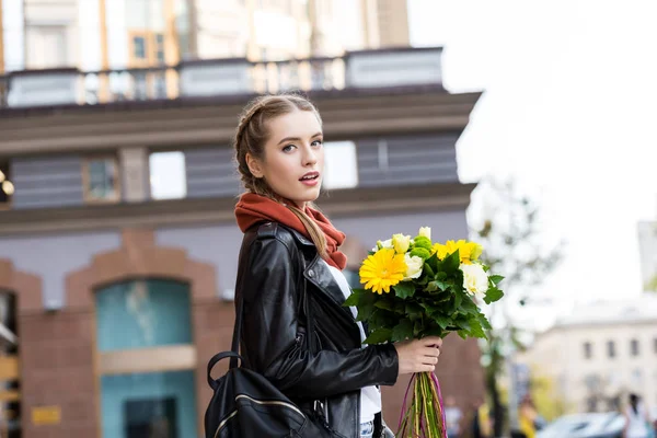 Young woman with bouquet of flowers — Stock Photo