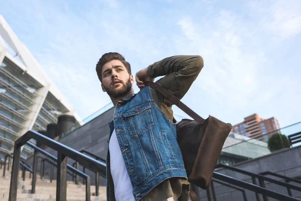 Stylish man with backpack on street — Stock Photo