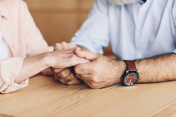 Senior couple holding hands — Stock Photo