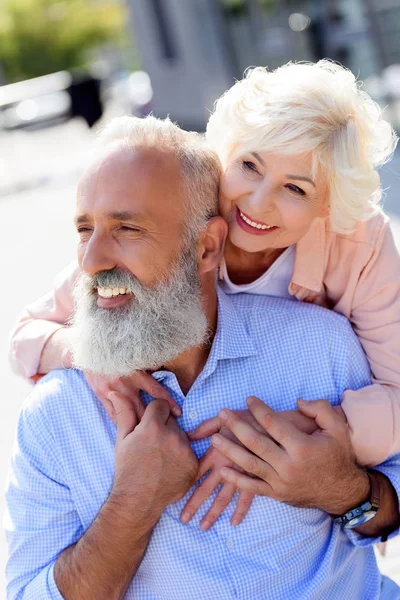 Mujer mayor abrazando marido - foto de stock