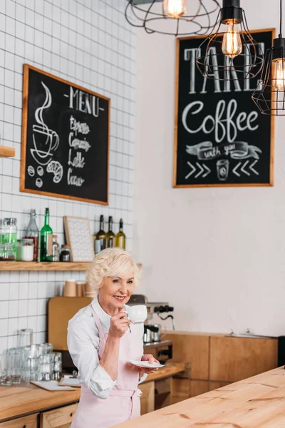 Cafe worker with cup of coffee — Stock Photo