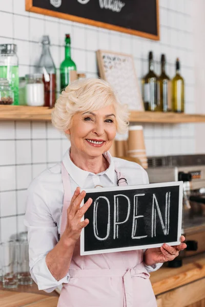 Senior worker with open chalkboard — Stock Photo