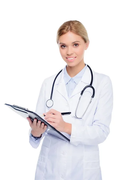 Mujer doctor escritura diagnóstico - foto de stock