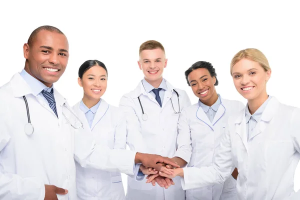 Multiethnic doctors with hands together — Stock Photo