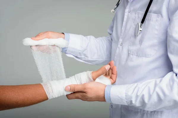 Doctor puting bandage on hand — Stock Photo