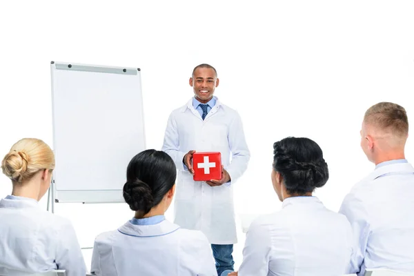 Doctor presenting first aid kit — Stock Photo