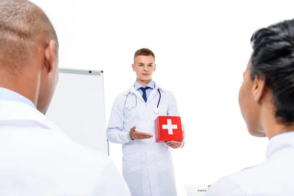 Doctor presenting first aid kit — Stock Photo