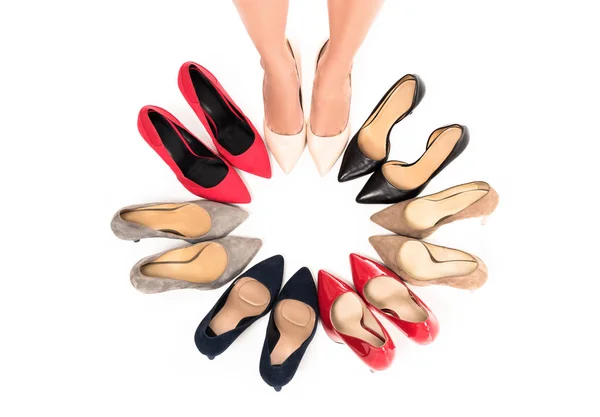 Woman standing in circle with shoes — Stock Photo