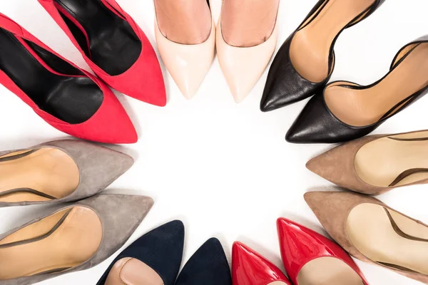 Woman standing in circle with shoes — Stock Photo