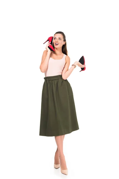 Woman holding pair of red shoes — Stock Photo