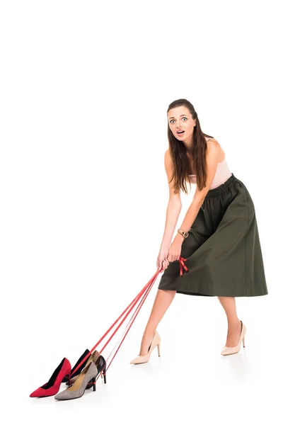 Woman holding shoes on ropes — Stock Photo