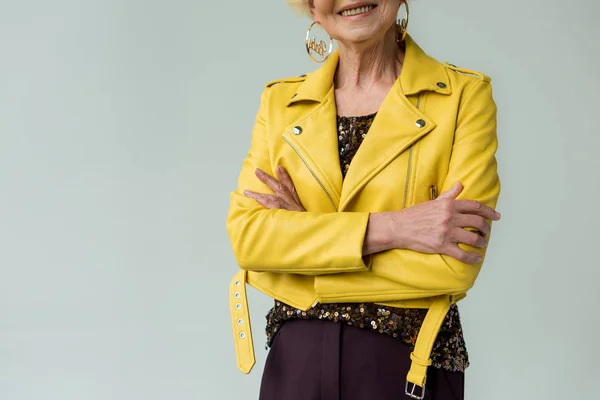 Senior woman in yellow leather jacket — Stock Photo