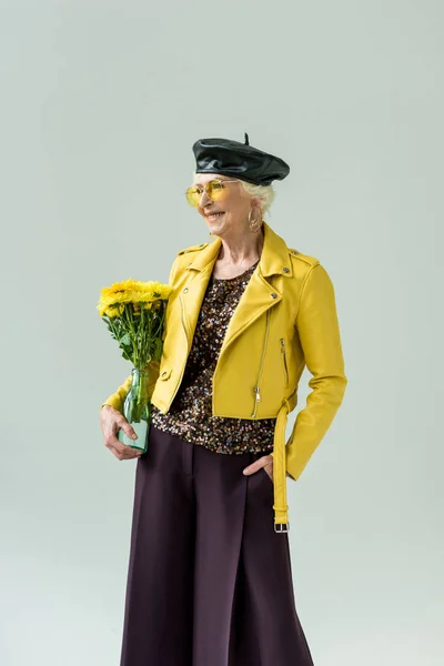 Stylish senior woman with flowers — Stock Photo