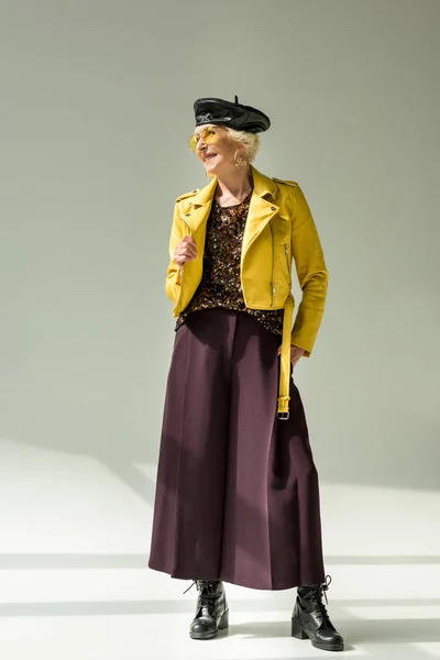 Senhora sênior em casaco de couro amarelo — Fotografia de Stock