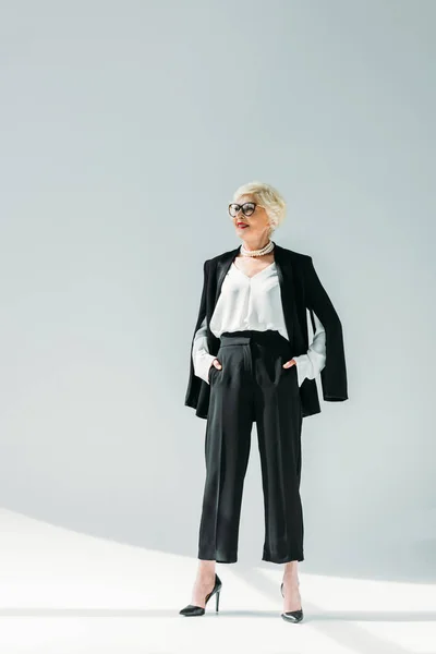 Senior lady in black suit — Stock Photo