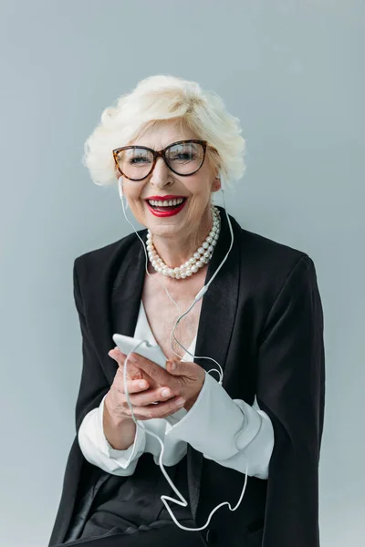 Senior lady listening music — Stock Photo