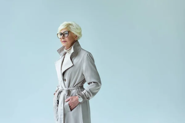 Senior lady in autumn trench coat — Stock Photo