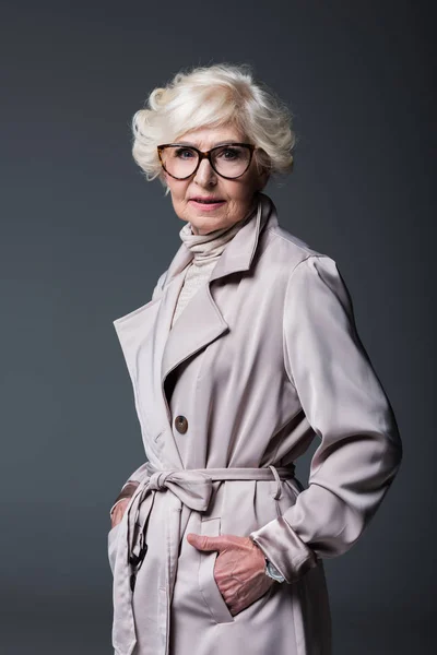 Senior woman in trench coat — Stock Photo