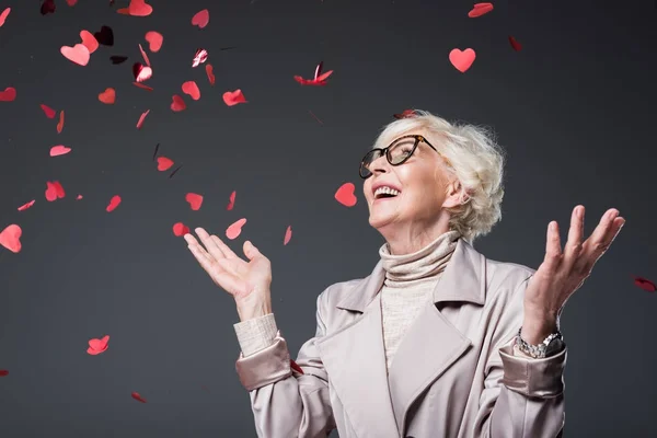 Lady with heart shaped confetti — Stock Photo