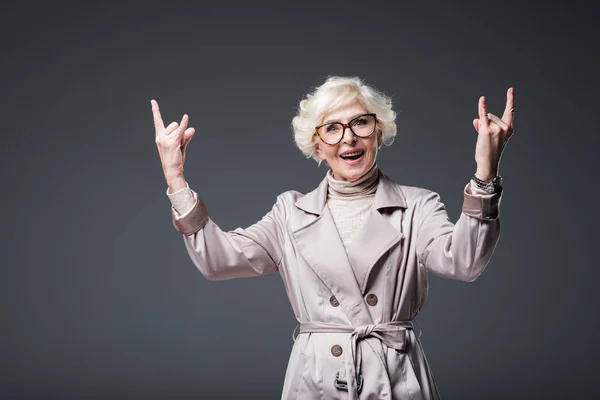 Senior lady showing rock signs — Stock Photo