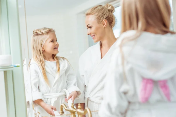 Mother and daughter in bathrobes — Stock Photo