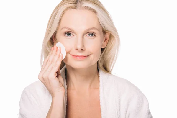 Mature woman using cosmetic sponge — Stock Photo