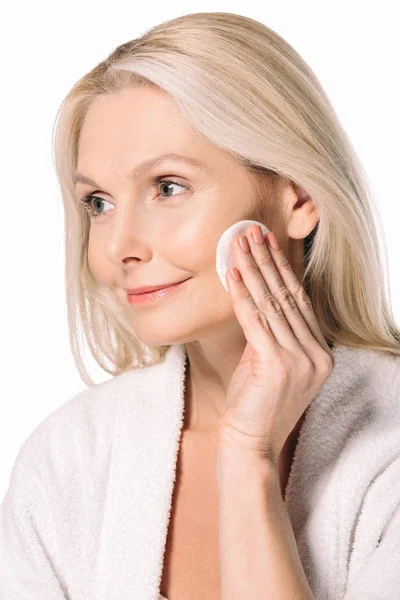 Mature woman using cosmetic sponge — Stock Photo