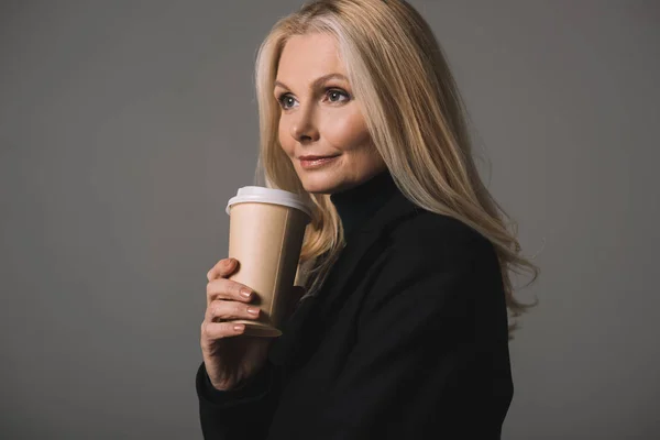 Mature woman with coffee to go — Stock Photo