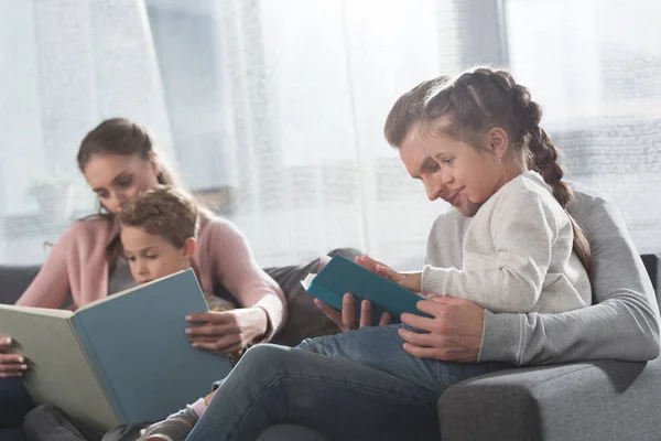 Родители учат детей читать дома — стоковое фото
