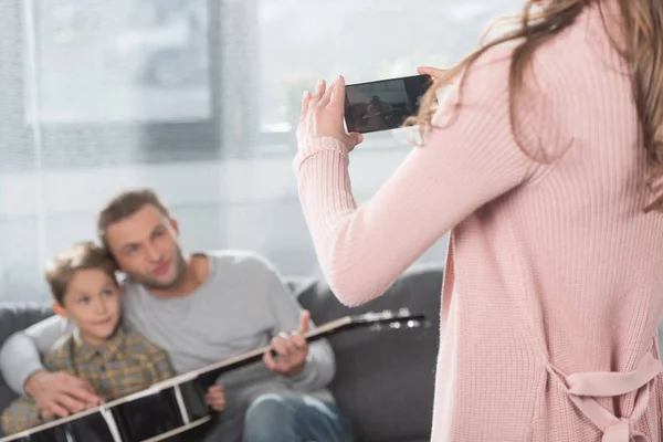 Mother taking photo of father with son — Stock Photo