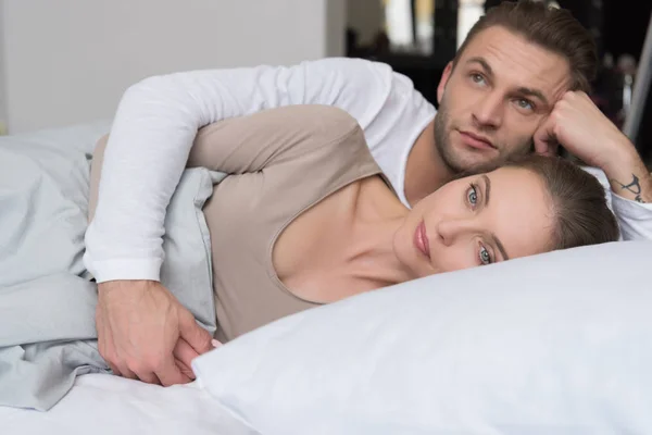 Boyfriend hugging girlfriend in bed — Stock Photo