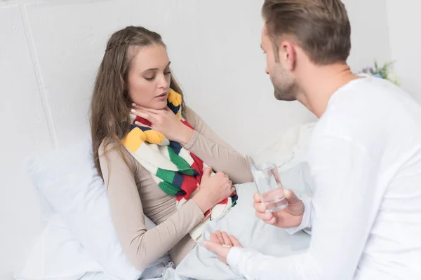 Boyfriend giving pill to sick girlfriend — Stock Photo