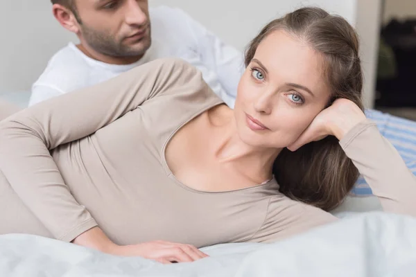 Boyfriend and girlfriend lying on bed — Stock Photo
