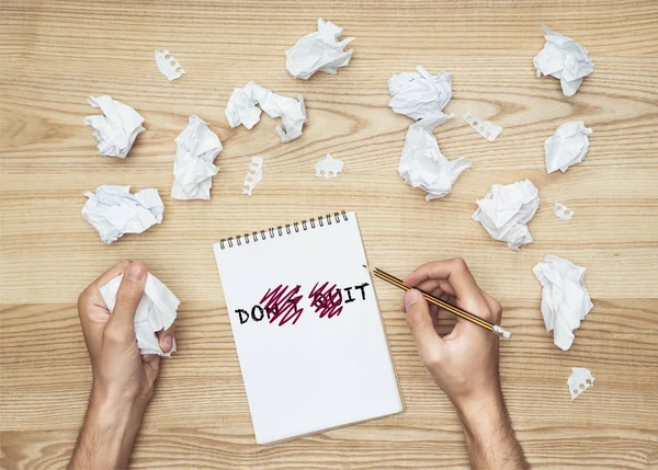 Businessman writing in notepad — Stock Photo